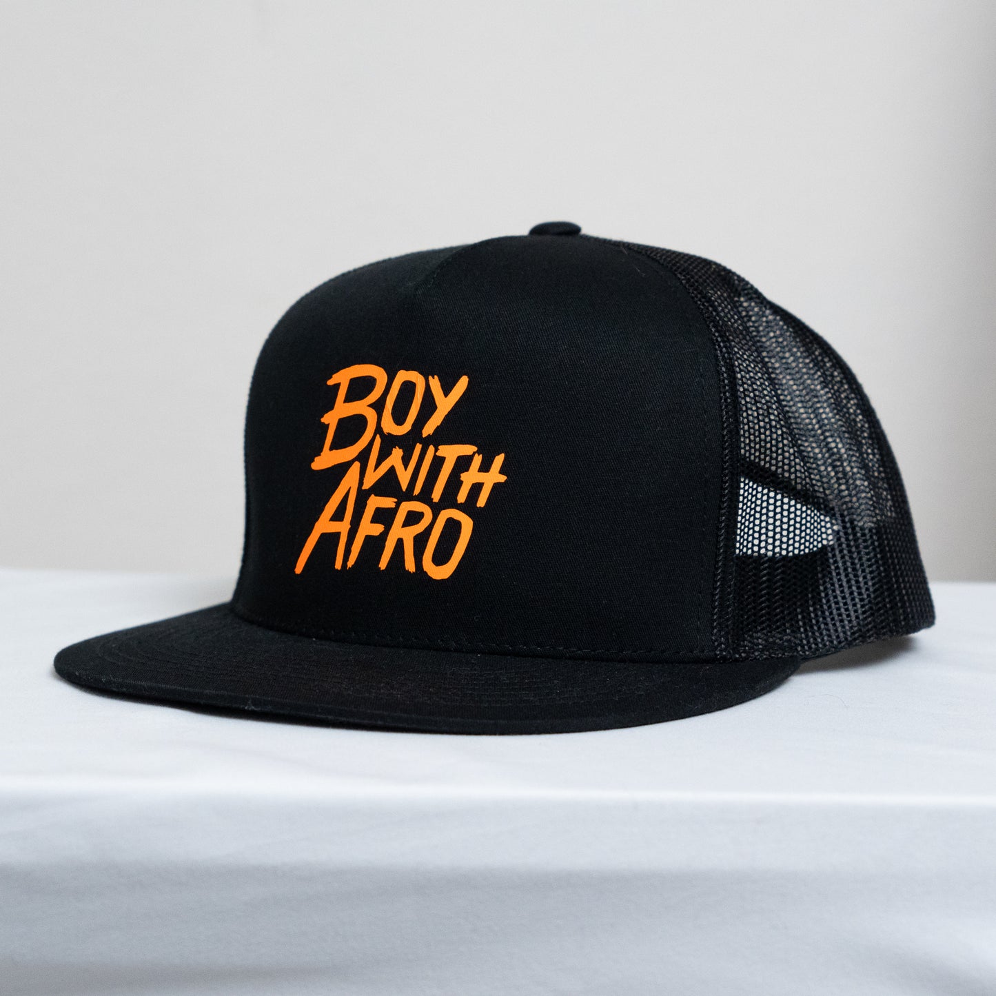 high-profile snapback with mesh back and BoyWithAfro logo on the front