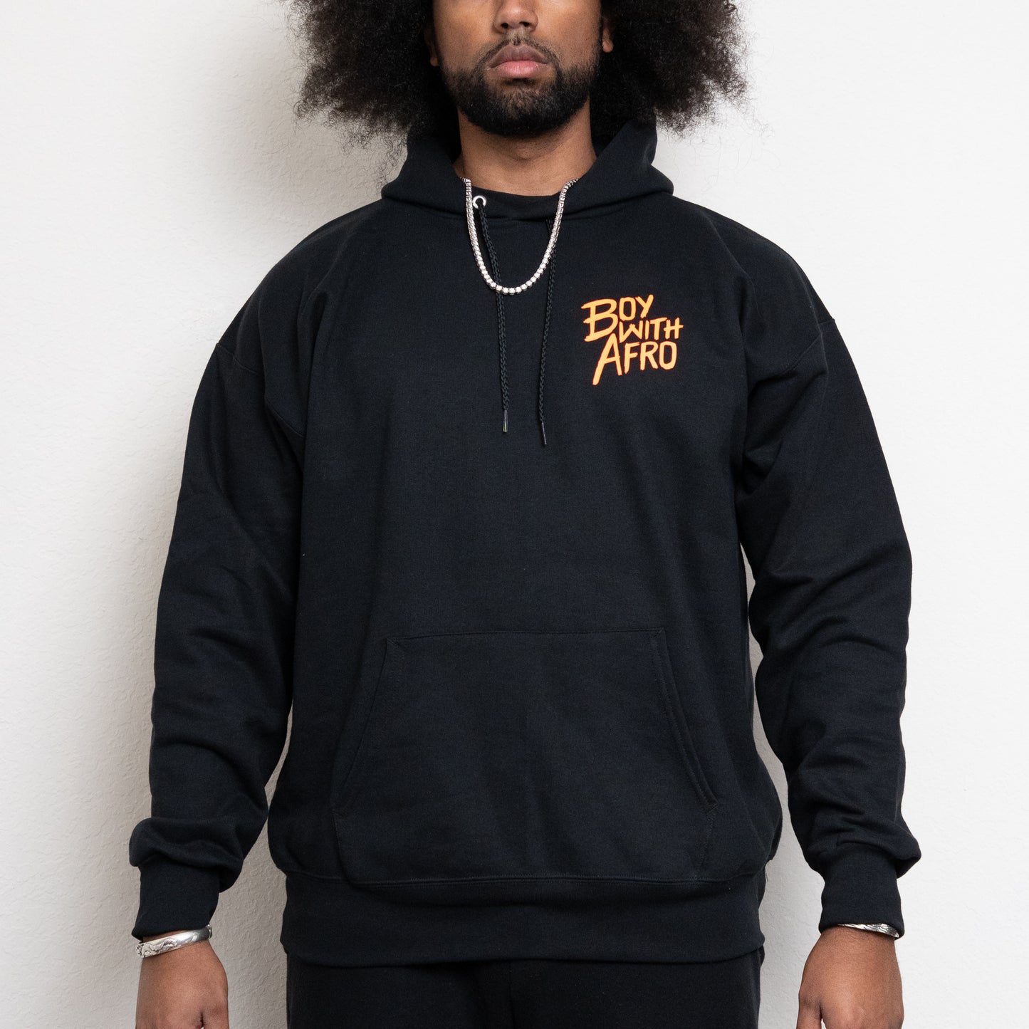 front-side of a black hoodie with the BoyWithAfro logo on the upper left chest