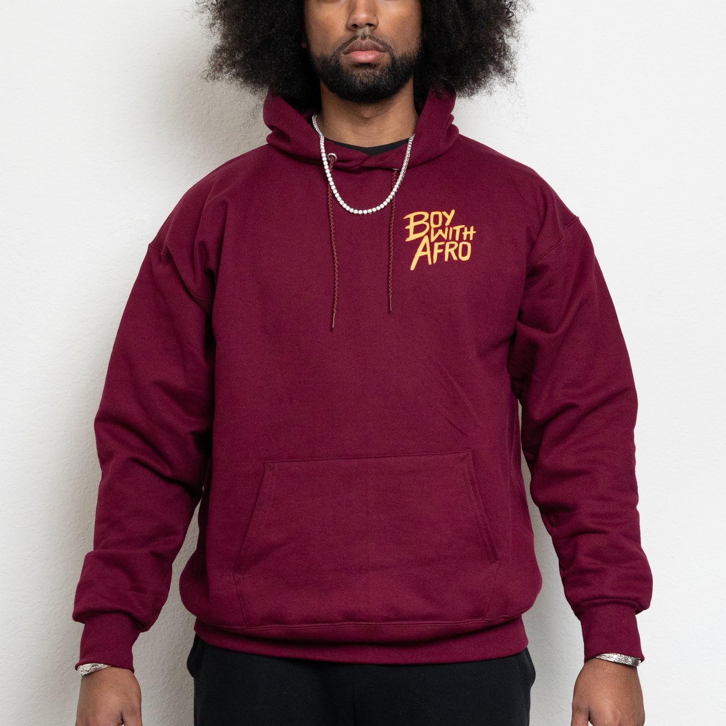 front-side of a maroon hoodie with the BoyWithAfro logo on the upper left chest