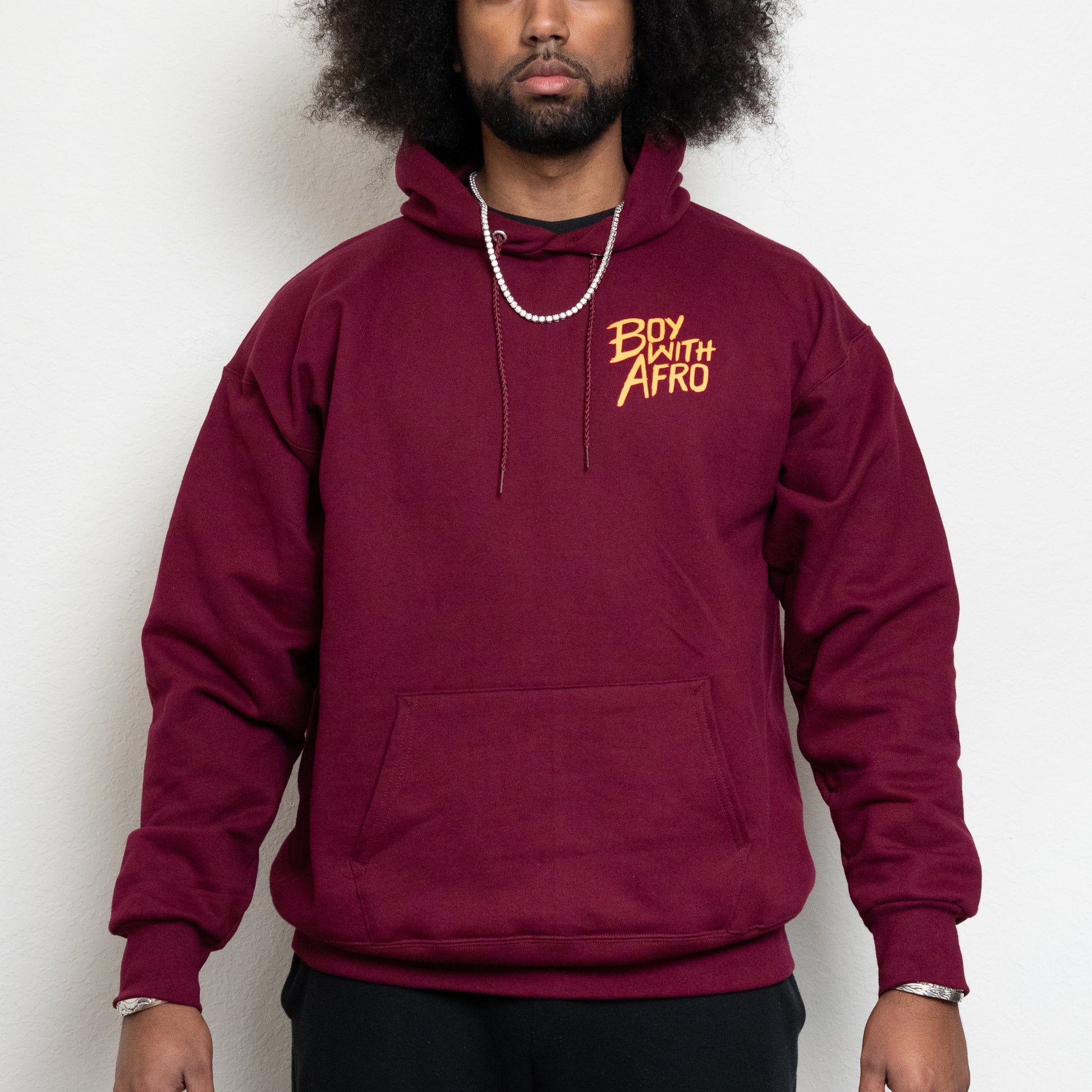 front-side of a maroon hoodie with the BoyWithAfro logo on the upper left chest