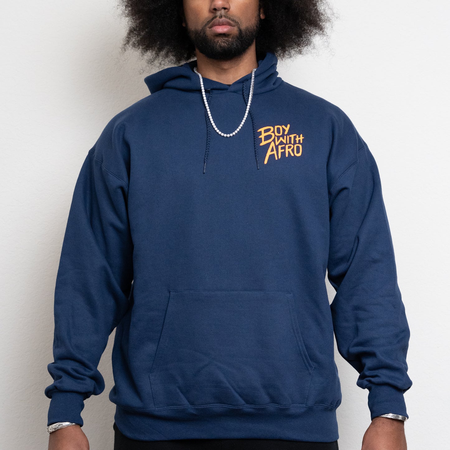 front-side of a navy hoodie with the BoyWithAfro logo on the upper left chest